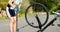 Middle age athlete pumping a bicycle tire with bike pump on country road 4k