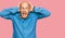 Middle age bald man wearing casual clothes crazy and scared with hands on head, afraid and surprised of shock with open mouth