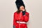 Middle age beautiful wales guard woman wearing traditional uniform over white background thinking concentrated about doubt with