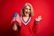 Middle age blonde patriotic woman holding united states flags celebrating independence day very happy and excited, winner