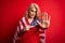 Middle age blonde patriotic woman wearing united states flag celebrating independence day with open hand doing stop sign with