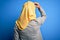 Middle age brunette business woman wearing muslim traditional hijab over blue background Backwards thinking about doubt with hand