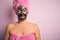 Middle age brunette woman wearing beauty black face mask over isolated pink background depressed and worry for distress, crying