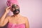 Middle age brunette woman wearing beauty black face mask over isolated pink background worried and stressed about a problem with