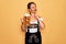Middle age brunette woman wearing german traditional oktoberfest dress drinking jar of beer serious face thinking about question,