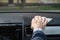 Middle age businessman in a blue suit cleaning front dashboard of a car using antivirus antibacterial wet wipe napkin