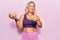 Middle age caucasian blonde woman wearing sportswear holding plastic brain as mental health concept smiling happy and positive,