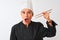Middle age chef woman wearing cap holding chopsticks over isolated white background scared in shock with a surprise face, afraid