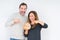 Middle age couple holding homemade fresh bread over isolated background very happy pointing with hand and finger