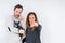 Middle age couple holding small chihuahua over isolated background pointing with finger to the camera and to you, hand sign,