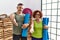 Middle age couple holding yoga mat smiling friendly offering handshake as greeting and welcoming