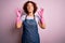 Middle age curly hair woman cleaning doing housework wearing apron and gloves relax and smiling with eyes closed doing meditation