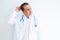 Middle age doctor man wearing stethoscope and medical coat over white background confuse and wonder about question