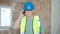 Middle age grey-haired man architect talking on walkie-talkie at construction site