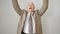 Middle age grey-haired man business worker throwing dollars smiling over isolated white background