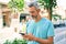 Middle age grey-haired man using smartphone at street of city thinking attitude and sober expression looking self confident