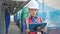 Middle age grey-haired woman builder using touchpad at street