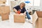 Middle age grey-haired woman smiling happy packing kitchen cardboard box at new home