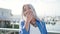 Middle age grey-haired woman standing with surprise expression at seaside