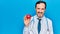 Middle age handsome cardiologist man wearing stethoscope holding plastic heart looking positive and happy standing and smiling
