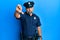 Middle age handsome man wearing police uniform looking unhappy and angry showing rejection and negative with thumbs down gesture