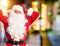 Middle age handsome man wearing Santa Claus costume and beard standing relaxing and stretching, arms and hands behind head and