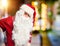 Middle age handsome man wearing Santa Claus costume and beard standing Suffering of backache, touching back with hand, muscular