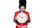 Middle age handsome wales guard man wearing traditional uniform holding big clock looking positive and happy standing and smiling