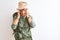 Middle age hiker woman wearing backpack canteen hat glasses over isolated white background with hand on head for pain in head