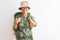 Middle age hiker woman wearing backpack canteen hat glasses over isolated white background smiling friendly offering handshake as