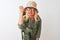 Middle age hiker woman wearing backpack hat canteen glasses over isolated white background angry and mad raising fist frustrated