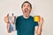 Middle age hispanic man holding italian coffee maker angry and mad screaming frustrated and furious, shouting with anger looking