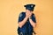 Middle age hispanic man wearing police uniform with sad expression covering face with hands while crying