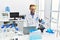 Middle age hispanic man wearing scientist uniform working at laboratory