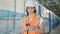 Middle age hispanic woman architect using smartphone at construction place