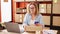 Middle age hispanic woman ecommerce business worker make photo to packages at office