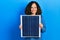 Middle age hispanic woman holding photovoltaic solar panel smiling with a happy and cool smile on face