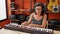 Middle age hispanic woman musician playing piano at music studio