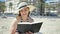 Middle age hispanic woman tourist sunbathing sitting on the towel reading a book at the beach