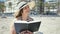 Middle age hispanic woman tourist sunbathing sitting on the towel reading a book at the beach