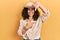 Middle age hispanic woman wearing explorer hat smiling making frame with hands and fingers with happy face