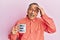 Middle age indian man drinking mug of coffee with best dad ever message stressed and frustrated with hand on head, surprised and