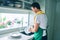 Middle age man with beard smiling happy washing dishes at home