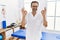 Middle age man with beard working at pain recovery clinic relax and smiling with eyes closed doing meditation gesture with fingers