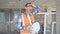 Middle age man builder holding hardhat sweating at construction site