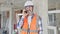 Middle age man builder smiling confident talking on smartphone at construction site