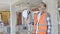 Middle age man builder tired taking out hardhat at construction site