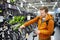 Middle age man choosing bicycle in sport store