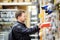 Middle age man choosing the right tool box in a hardware store