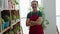 Middle age man florist smiling confident standing with arms crossed gesture at florist